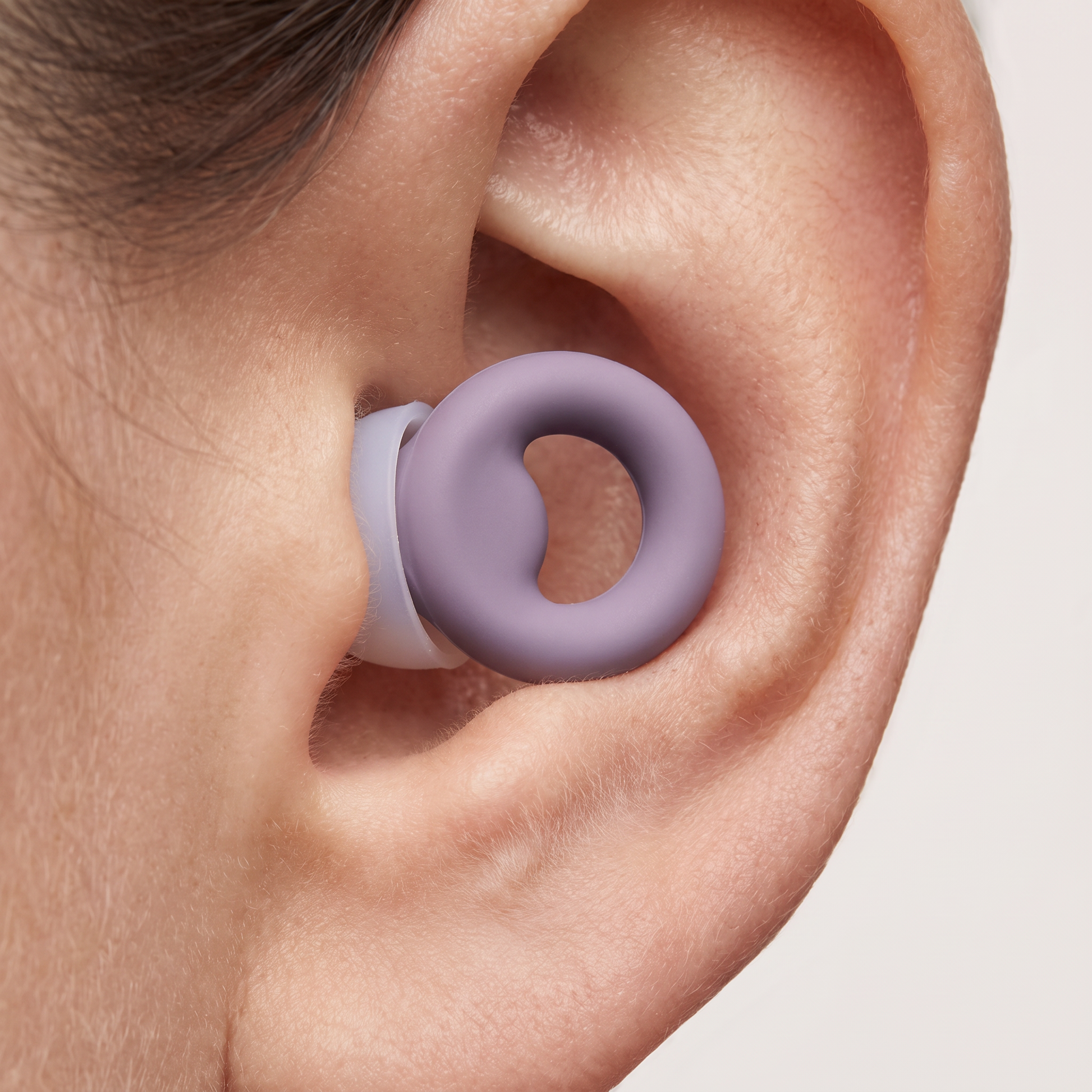 A Nova earplug worn in the ear, sitting flush